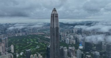 view of the city with green gardens and buildings