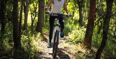 Mountain biking in summer forest