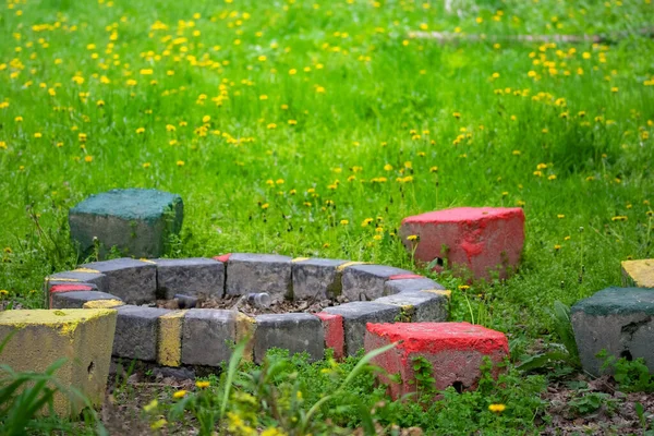 Stone Fireplace Garden Colorful Concrete Bench Green Grass Yellow Flowers — ストック写真