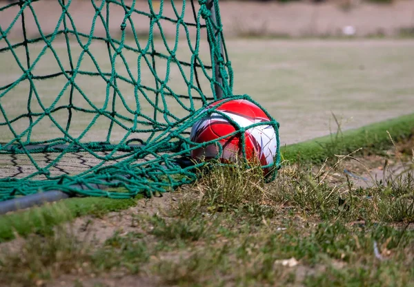 Soccer ball in the green goal net of a soccer goal