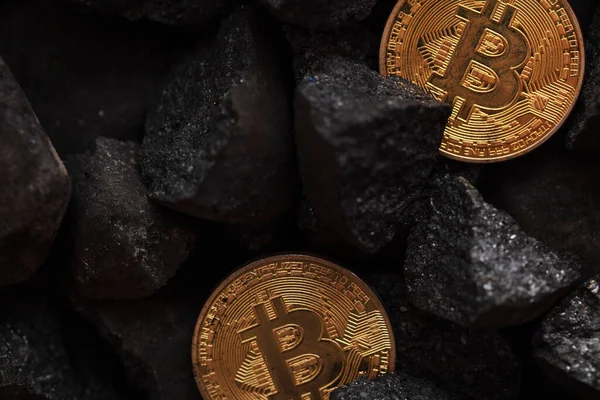 Concepto minero Bitcoin. Moneda de oro bitcoin criptomoneda en una pila de carbón — Foto de Stock