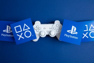 LONDON, UK - July 2022: Sony playstation logo against a blue background. Playstation is a video game brand. clipart