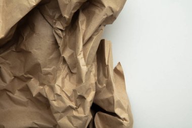 crumpled brown kraft paper background. Recycle old brown paper texture.