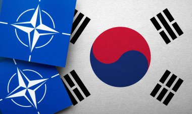 LONDON, UK - August 2022: NATO North Atlantic Treaty Organization military alliance logo on a South Korea flag.