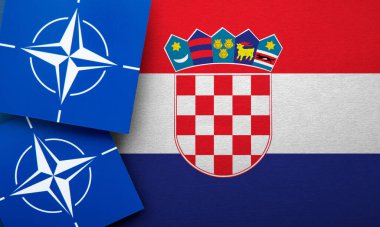 LONDON, UK - August 2022: NATO North Atlantic Treaty Organization military alliance logo on a Croatia flag.