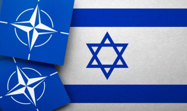 LONDON, UK - August 2022: NATO North Atlantic Treaty Organization military alliance logo on a Israel flag.