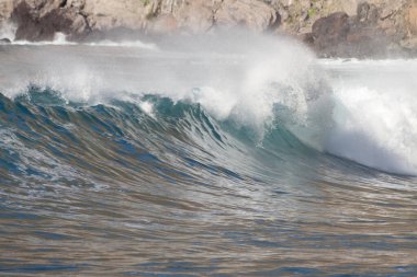 Bol köpüklü dalgalar, Atlantik Okyanusu 'nun volkanik siyah kumlu sahilinde, arka planda kayaları ve kayaları gören dalgalar. Los Gigantes, Tenerife, Kanarya Adaları 'ndan Cliff. İspanya
