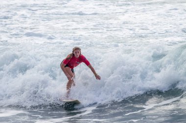TENERIFE, SPAIN, NOVEMBER-03-2013: girl surfing in a surfing competition, performing several spectacular maneuvers on the wall of the wave. Tenerife, Canary Islands, Spain