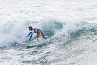 TENERIFE, SPAIN, NOVEMBER-03-2013: girl surfing in a surfing competition, performing several spectacular maneuvers on the wall of the wave. Tenerife, Canary Islands, Spain