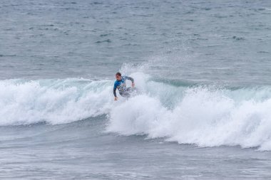 TENERIFE, SPAIN, 03-NOVEMBER-2013: Adam serbest sörf yapıyor ve dalganın duvarında radikal manevralar yapıyor. Tenerife, Kanarya Adaları, İspanya