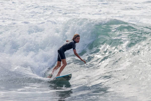 TENERIFE, SPAIN, NOVEMBER-03-2013: çocuk sörf yarışmasında sörf yapıyor, dalganın duvarında birkaç harika manevra yapıyor. Tenerife, Kanarya Adaları, İspanya