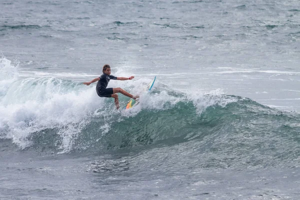 TENERIFE, SPAIN, NOVEMBER-03-2013: çocuk sörf yarışmasında sörf yapıyor, dalganın duvarında birkaç harika manevra yapıyor. Tenerife, Kanarya Adaları, İspanya