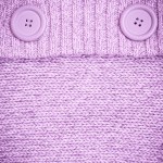 Background with Knitted lilac sweater with buttons Background with Knitted lilac sweater with buttons