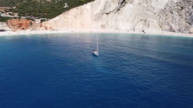 Aerial view of sailing boat on Porto Katsiki beach. Tropical turquoise sea in summer season on Lefkada island.