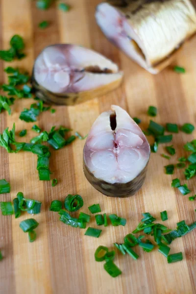 Bloater and green onion on the board — Stock Photo, Image