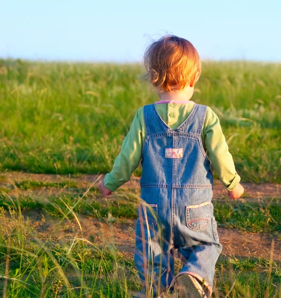 Sweet child in the jeans coverall — Stock Photo, Image