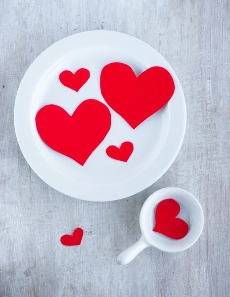 Big and small hearts on the white china dishes — Stock Photo, Image
