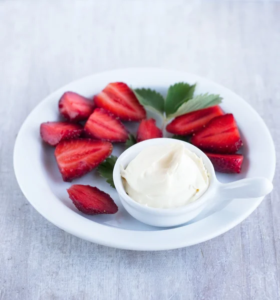 Milk cream on the white china and red rich strawberry — Stock Photo, Image
