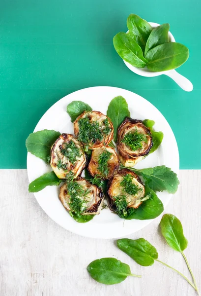 Fried vegetable marrow with dill and garlic on the round white p — Stock Photo, Image