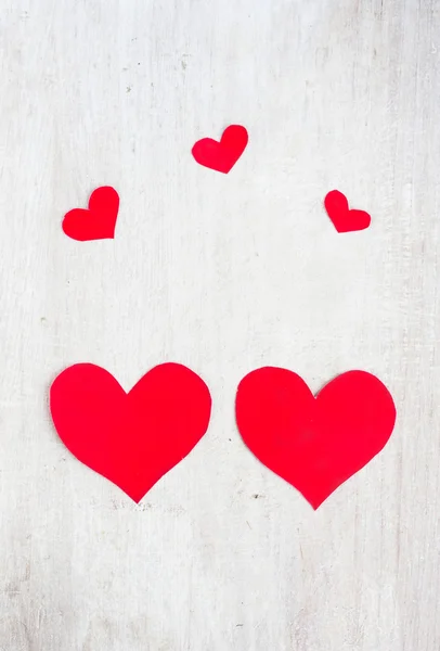 Big and small hearts on the white wood board — Stock Photo, Image