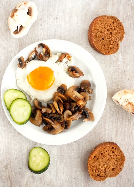 Fried eggs and champignons — Stock Photo, Image