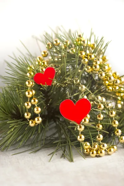 Pine branche adorned beads and hearts — Stock Photo, Image