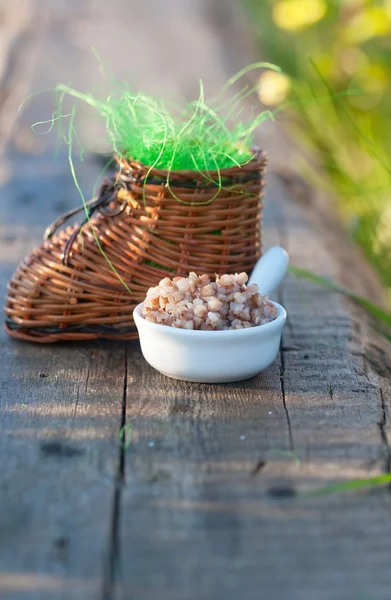 Wicker toy clog and boiled buckwheat — Stock Photo, Image