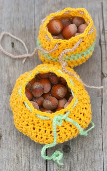 Crocheted bag with hazelnut — Stock Photo, Image