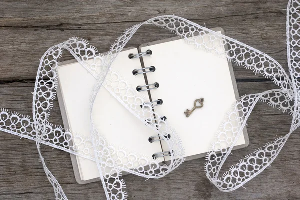 Romantic notebook and white lace — Stock Photo, Image