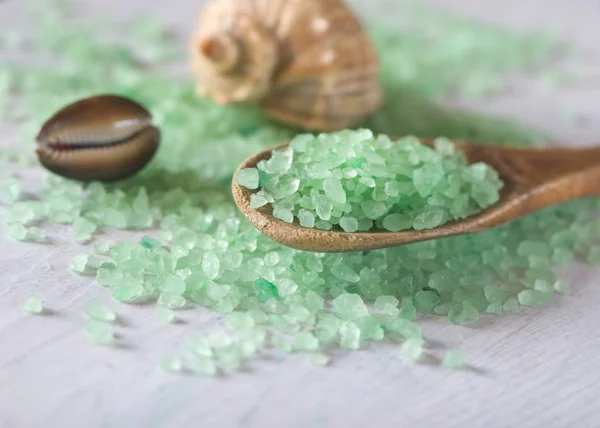 Salt bath on a wooden spoon and seashells — Stock Photo, Image