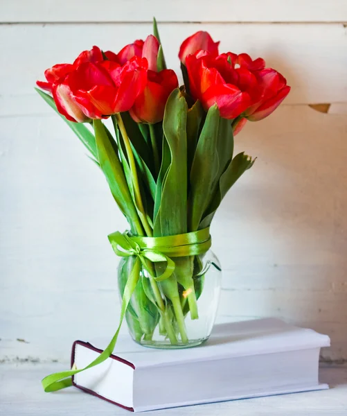 Bouquet of tulips in a glass jar — Stock Photo, Image