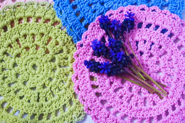 Blue spring flowers on a crochet napkins — Stock Photo, Image