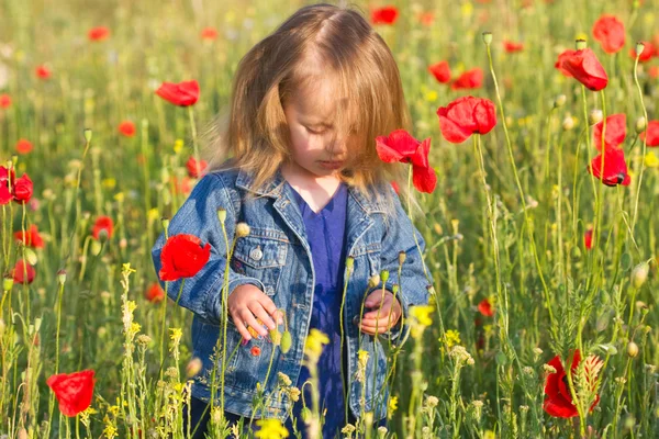 Beautiful little girl with her hair in a denim jacket — Stock Photo, Image
