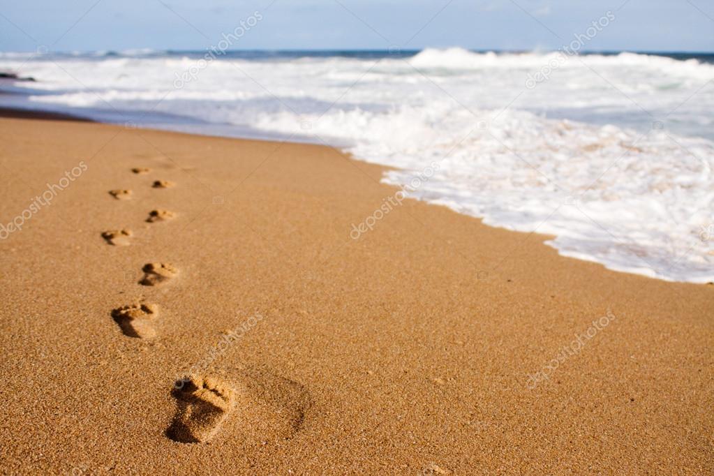 Footprints leading into the sea
