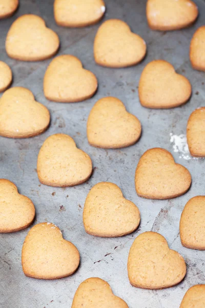 Home made heart shaped cookies on baking tray — Stock Photo, Image