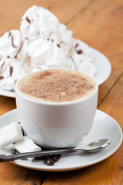 Cappuccino with foam and meringues on white plate — Stock Photo, Image