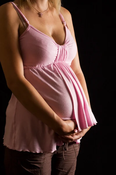 Young Caucasian female holding her pregnant belly — Stock Photo, Image