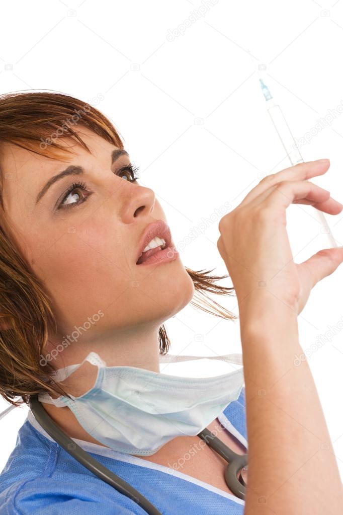 Attractive young Caucasian female doctor holding syringe