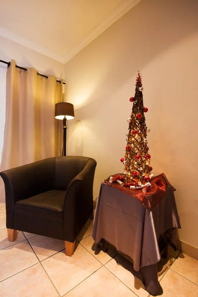 Lounge interior with tub chair and Christmas tree — Stock Photo, Image