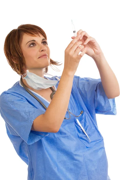Young Caucasian female doctor inspecting filled syringe Royalty Free Stock Photos