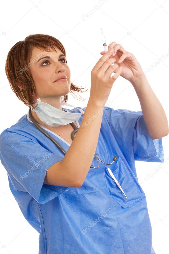 Young Caucasian female doctor inspecting filled syringe