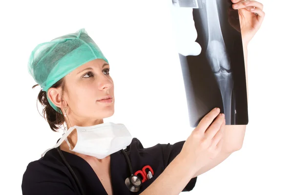 Young Caucasian female doctor examining an x-ray — Stock Photo, Image