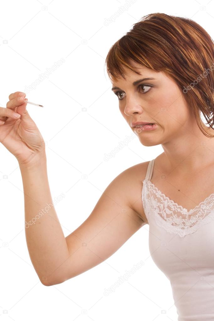 Stressed out Caucasian female holding a fever pen