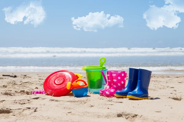 Jouets en plastique coloré pour enfants sur la plage — Photo