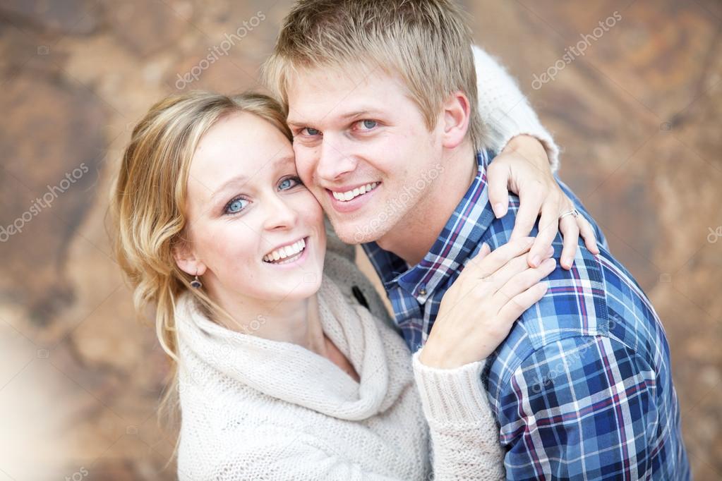 Young couple in love looking up at viewer