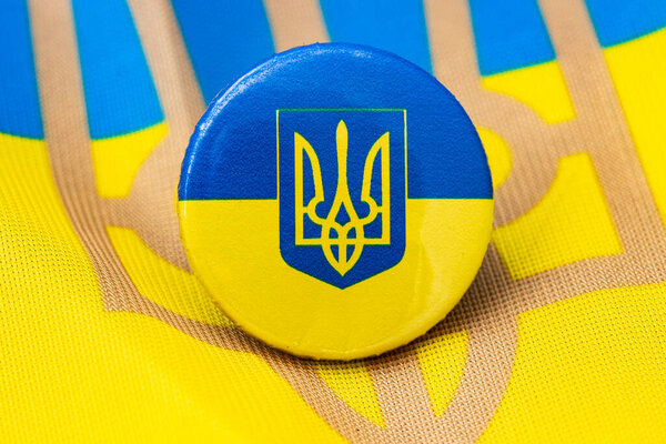 A Ukrainian button on a Ukrainian flag