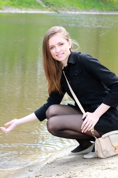 Beautiful girl and spring at the river — Stock Photo, Image