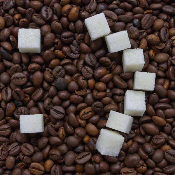 Funny composition of sugar in the form of a emoticon on the background of coffee beans Stock Image