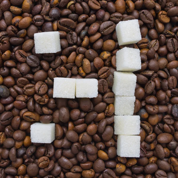 Funny composition of sugar in the form of a emoticon on the background of coffee beans Royalty Free Stock Images