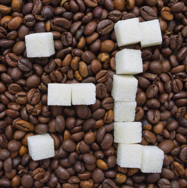 Funny composition of sugar in the form of a emoticon on the background of coffee beans Stock Photo